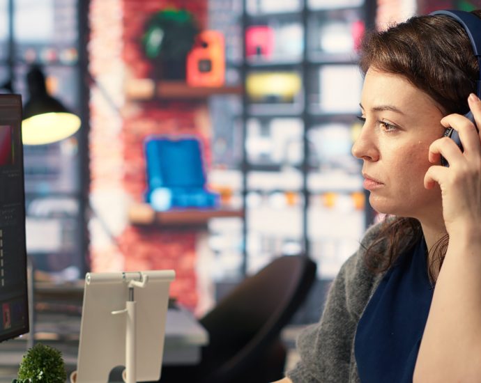 Creative professional using editing software with headphones, representing AI-driven content personalization and reducing listener fatigue through intelligent discovery systems.