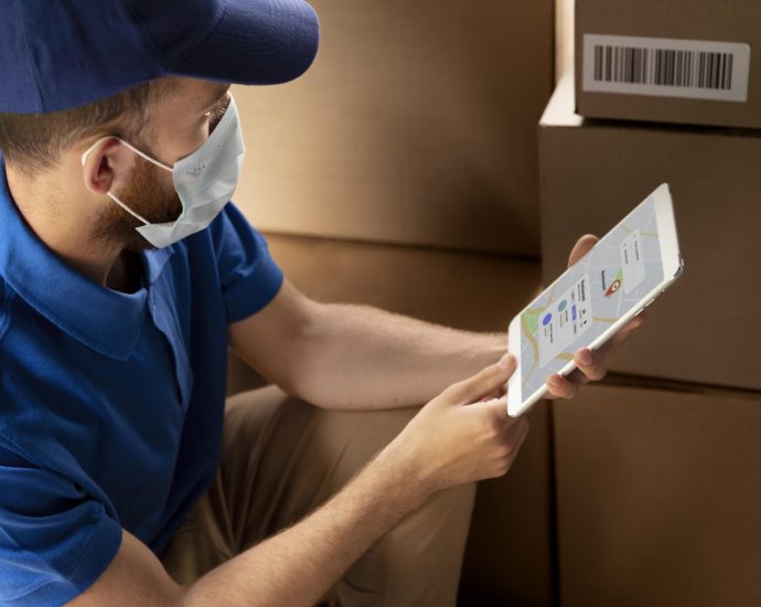 Delivery worker using a tablet to track packages and routes, showcasing AI-powered predictive analytics for real-time logistics and last-mile optimization.