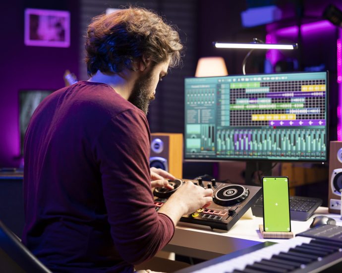 Music producer working on a digital mixing console, illustrating generative AI and real-time analytics optimizing content creation and audience engagement.