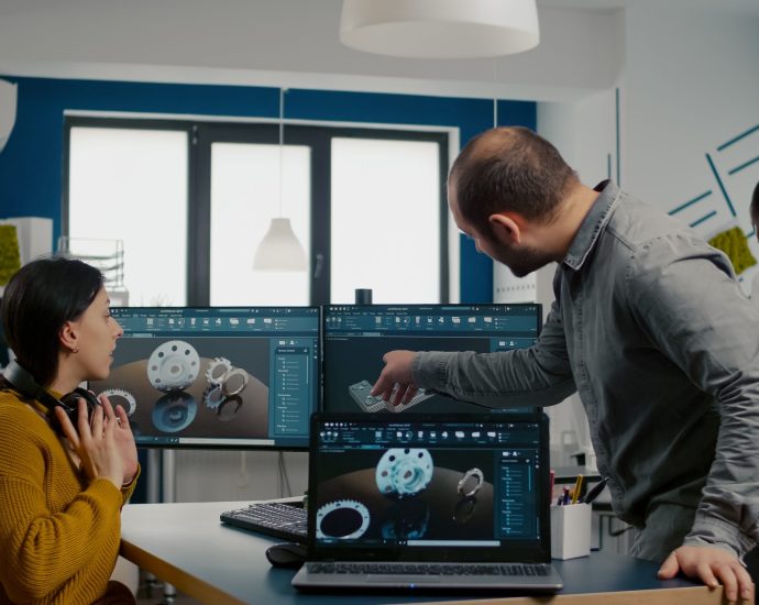 Engineering team collaborating on product design using digital tools and automation to improve operational efficiency