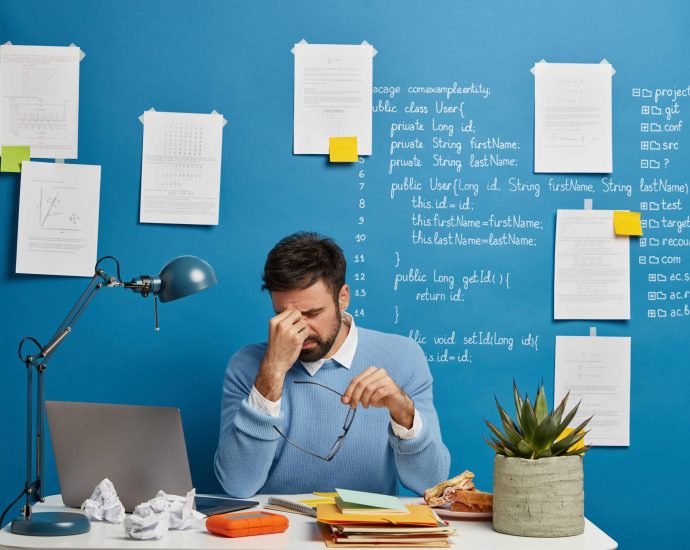 Exhausted professional managing event tasks manually, representing planning burnout and inefficiencies without automation