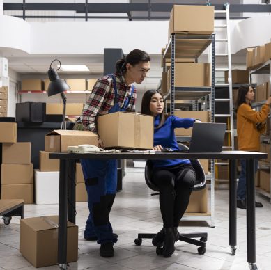 Small business team managing inventory and logistics operations using AI-driven workflow automation powered by LLM orchestration and predictive analytics.